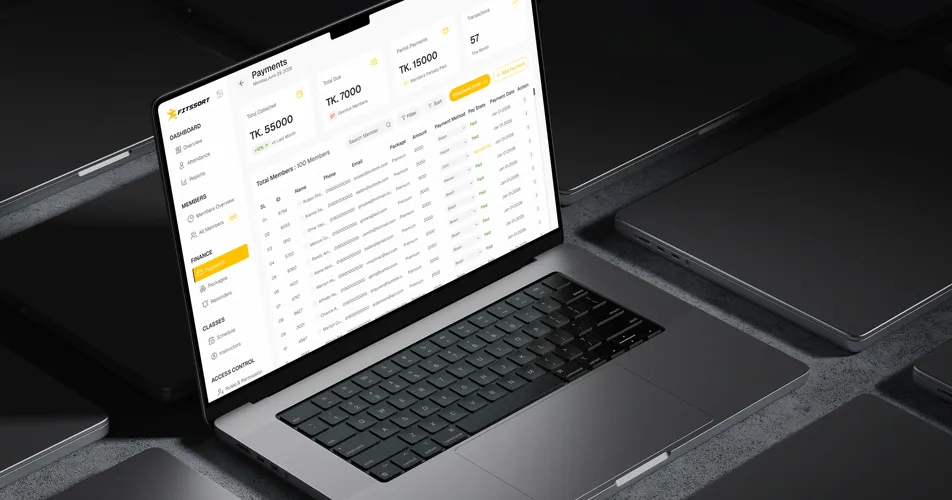 A MacBook on a dark desk showing the FitSSort payments table