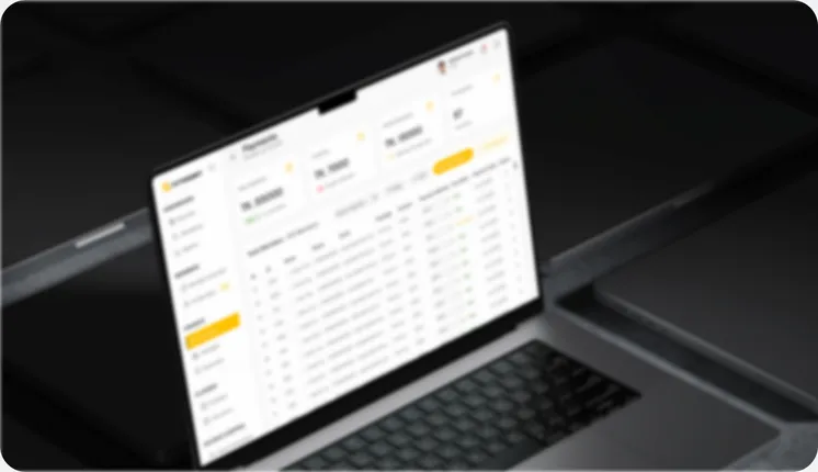 FitSSort's payments table open on a laptop on a dark desk.