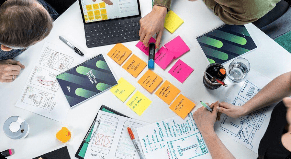 A team mapping ideas on sticky notes around a table